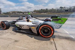 Nuclear Clean Air Energy branded IndyCar racing vehicle on track at a major motorsports event